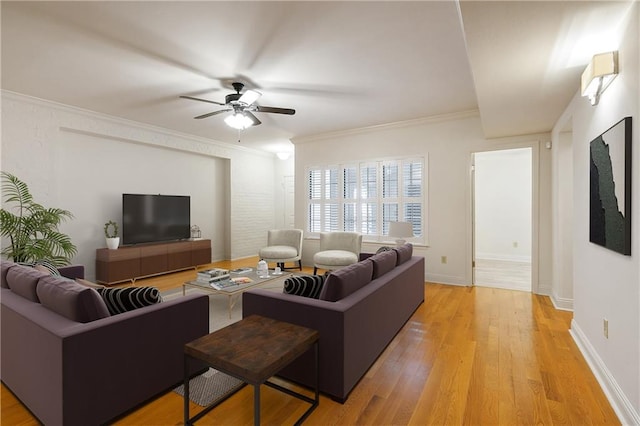 living room featuring ornamental molding, ceiling fan, and light hardwood / wood-style flooring