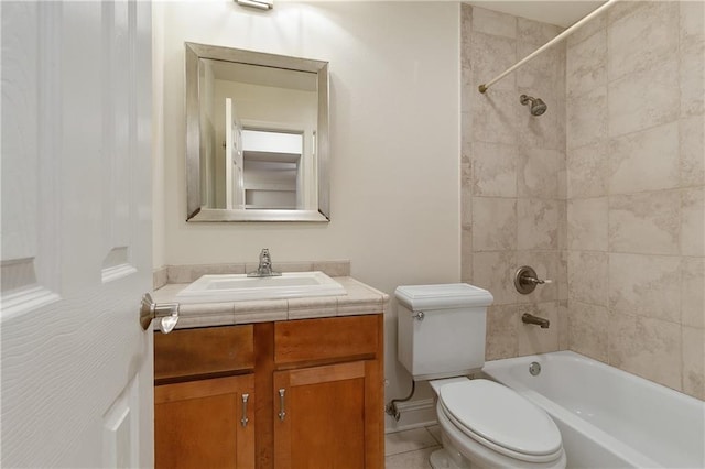 full bathroom featuring tiled shower / bath combo, vanity, tile floors, and toilet