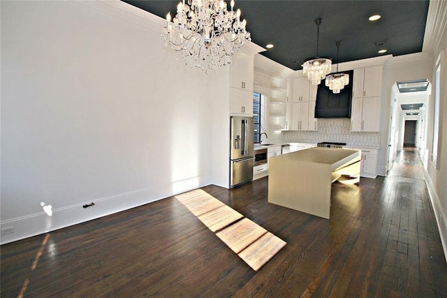 kitchen featuring a center island, white cabinets, backsplash, dark hardwood / wood-style flooring, and a chandelier