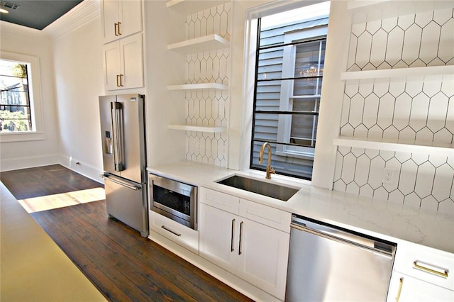 kitchen featuring appliances with stainless steel finishes, dark wood-type flooring, white cabinetry, and sink