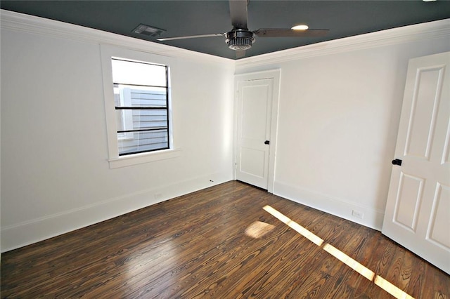 spare room with dark hardwood / wood-style flooring, ceiling fan, and crown molding