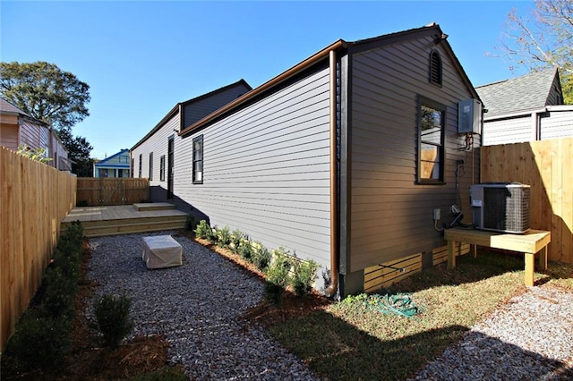 view of side of property with central air condition unit