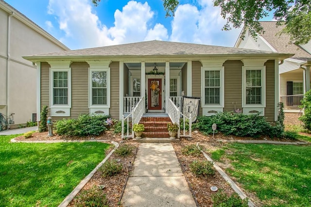 view of front of property with a porch and a front yard