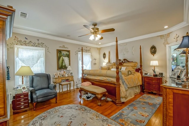 bedroom with ornamental molding, ceiling fan, and hardwood / wood-style floors