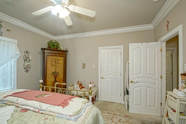 carpeted bedroom featuring crown molding and ceiling fan