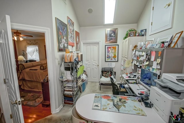 carpeted home office featuring ceiling fan and vaulted ceiling