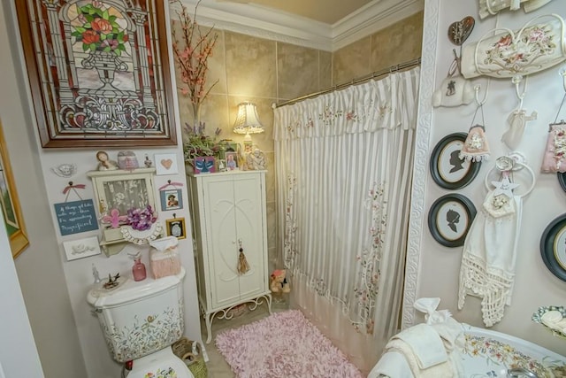 bathroom featuring crown molding and toilet