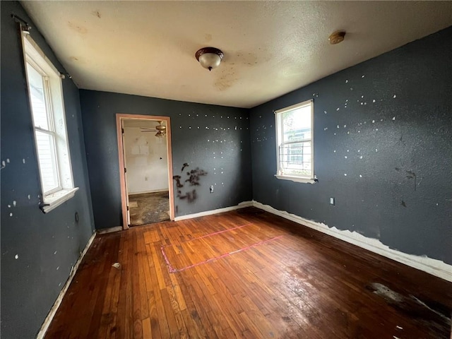 unfurnished room with hardwood / wood-style floors