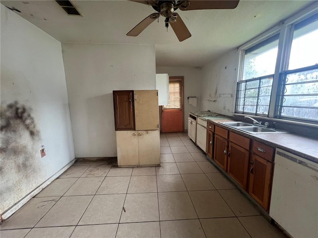 kitchen with sink, ceiling fan, light tile floors, and white dishwasher