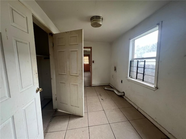 unfurnished bedroom featuring a closet and light tile flooring