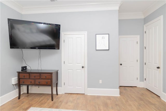 bedroom featuring ornamental molding and wood-type flooring