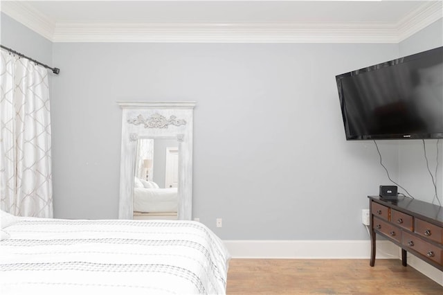 bedroom featuring ornamental molding and wood-type flooring