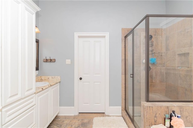 bathroom with walk in shower and vanity