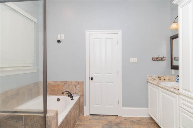 bathroom with a relaxing tiled bath, tile flooring, and vanity