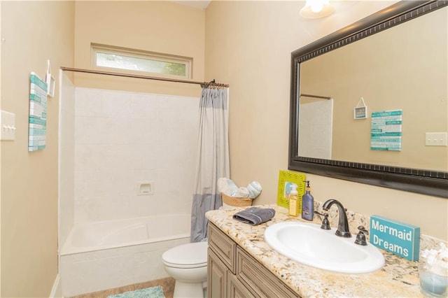 full bathroom featuring shower / bath combo, toilet, and vanity