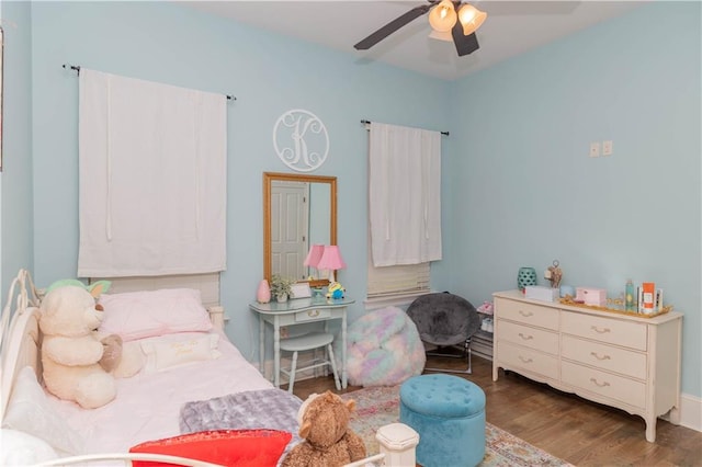 bedroom with dark hardwood / wood-style floors and ceiling fan