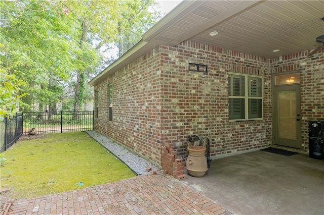 view of property exterior featuring a patio and a yard