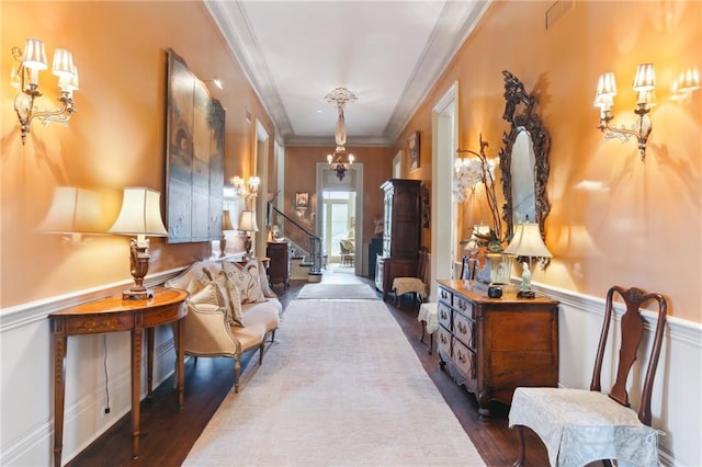 interior space featuring ornamental molding, dark hardwood / wood-style flooring, and a chandelier