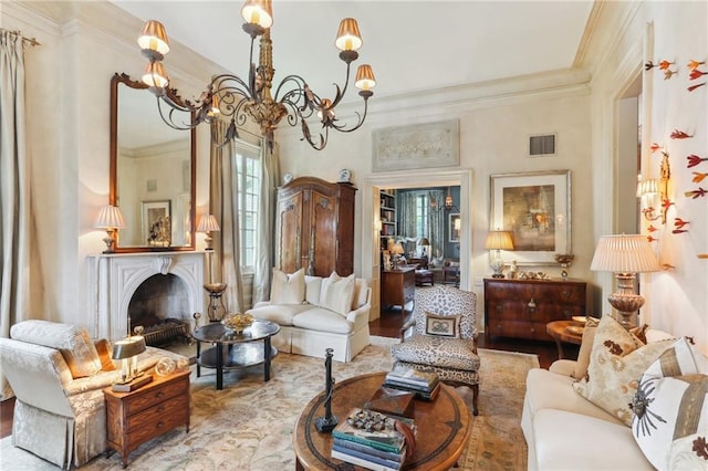 living room with ornamental molding, an inviting chandelier, and light hardwood / wood-style floors