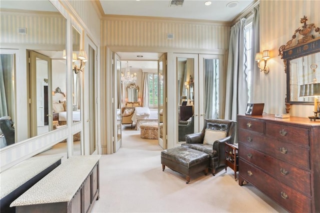 sitting room with light carpet and a chandelier