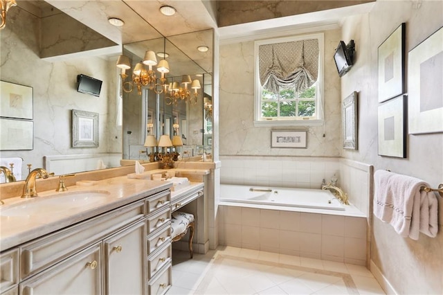 bathroom featuring vanity, tile patterned flooring, a notable chandelier, and tiled bath