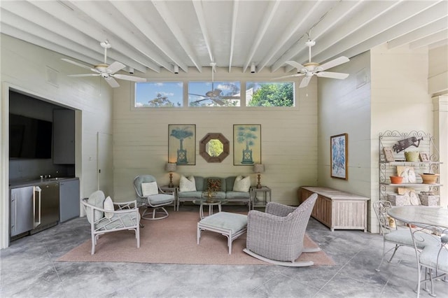 interior space with ceiling fan and beam ceiling