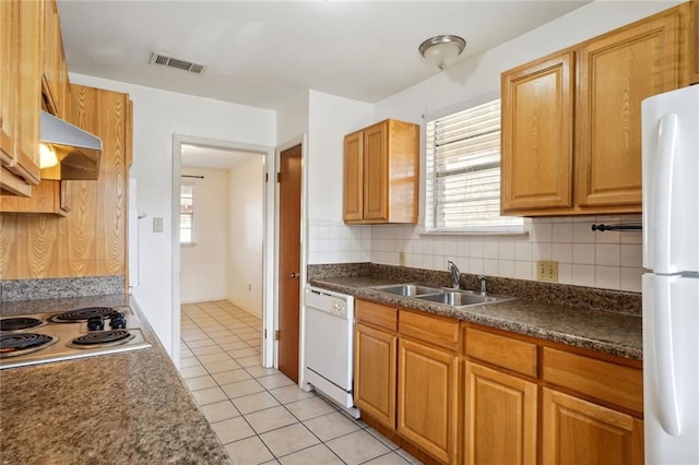 kitchen featuring white appliances, light tile patterned floors, decorative backsplash, and sink