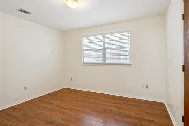 unfurnished room with hardwood / wood-style floors