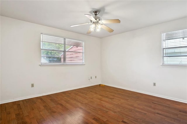 unfurnished room with ceiling fan and dark hardwood / wood-style flooring