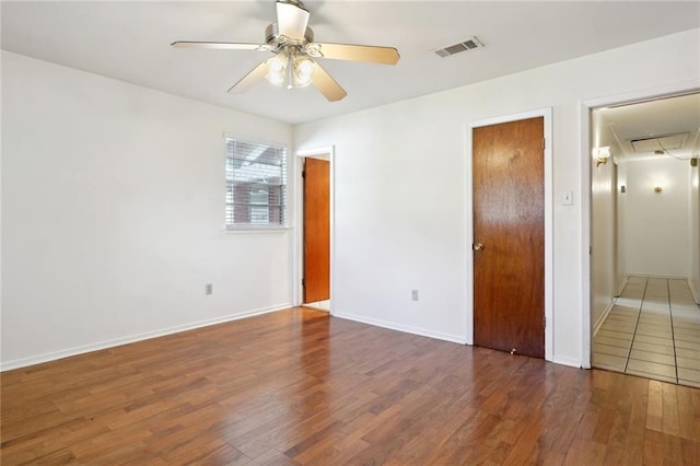 unfurnished bedroom with dark wood-type flooring and ceiling fan