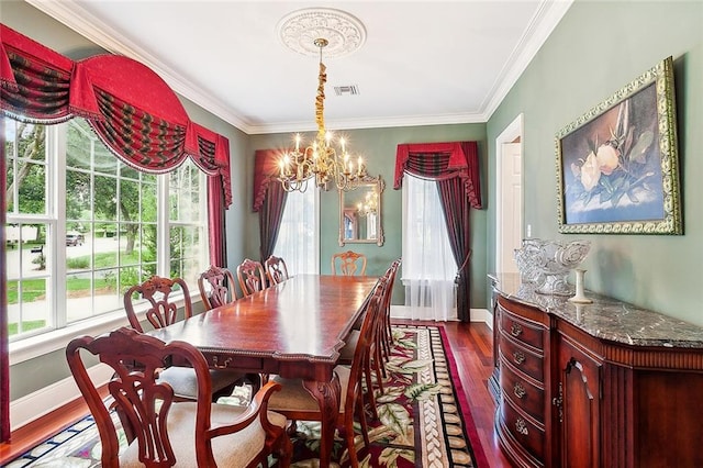 dining room featuring ornamental molding, dark wood-type flooring, and an inviting chandelier