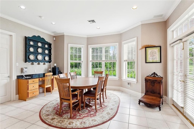 tiled dining space featuring crown molding