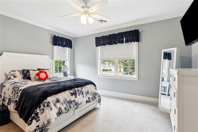 carpeted bedroom with ceiling fan, multiple windows, and crown molding