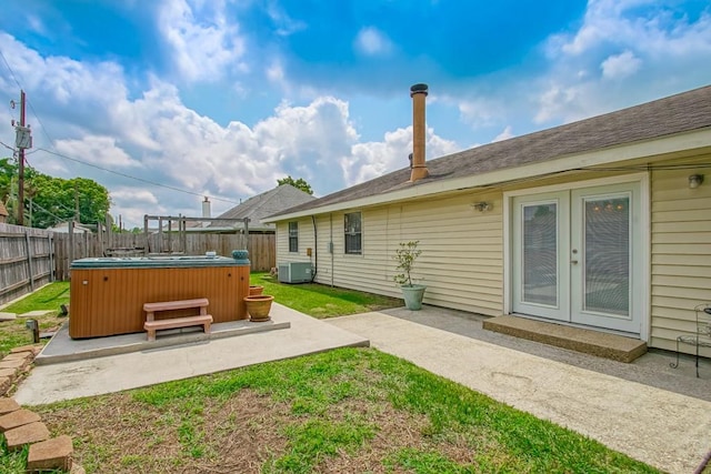 view of yard with a patio, a hot tub, and central air condition unit