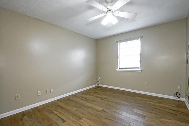 spare room with a textured ceiling, ceiling fan, and hardwood / wood-style floors