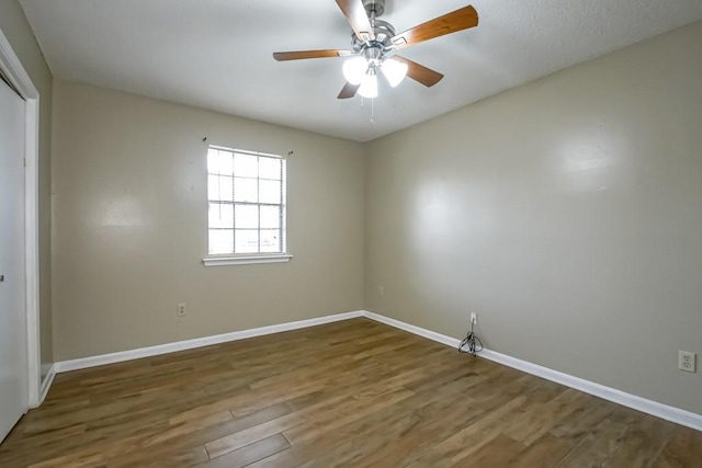 empty room featuring hardwood / wood-style floors and ceiling fan