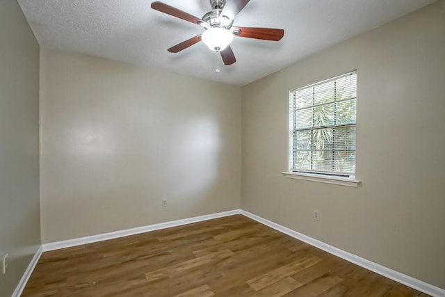 spare room featuring hardwood / wood-style flooring, ceiling fan, and a textured ceiling