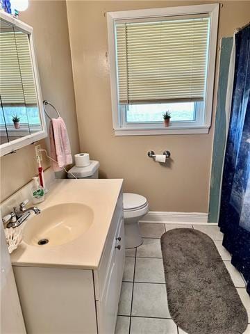 bathroom with tile floors, oversized vanity, and toilet