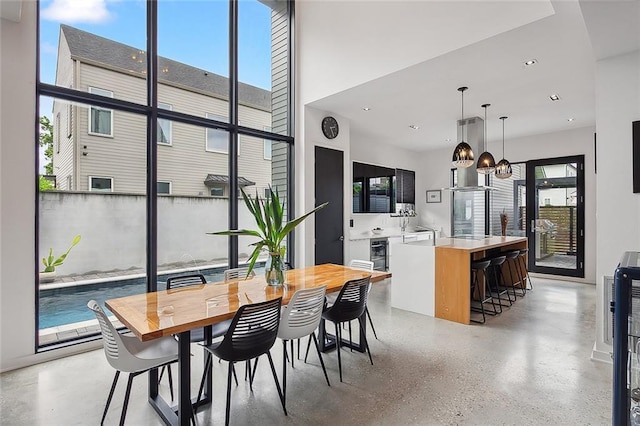 dining area featuring a healthy amount of sunlight and beverage cooler