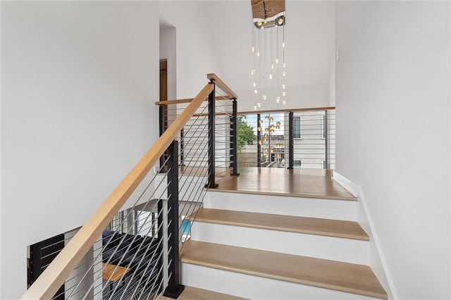 stairway with a chandelier