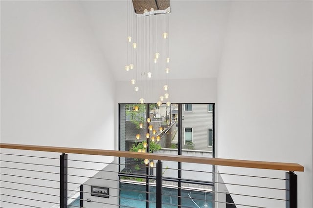 staircase with an inviting chandelier