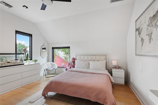 bedroom featuring lofted ceiling, light hardwood / wood-style flooring, and ceiling fan