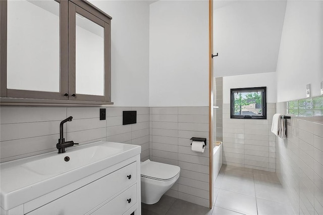 bathroom featuring tile walls, large vanity, tile floors, and toilet