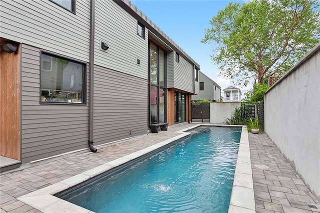 view of swimming pool with a patio and pool water feature