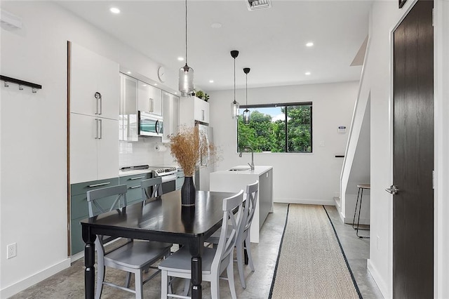 dining area with light hardwood / wood-style floors and sink