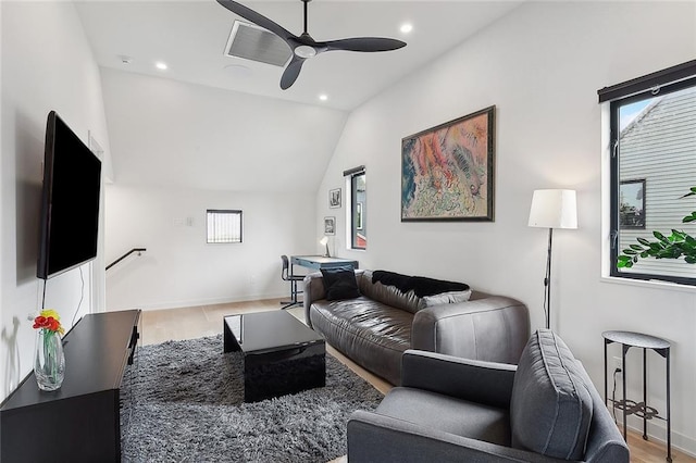 living room with wood-type flooring, ceiling fan, and vaulted ceiling