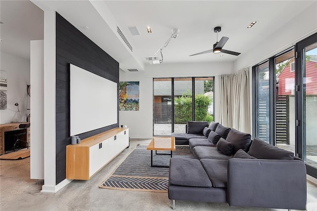 living room featuring ceiling fan and concrete floors