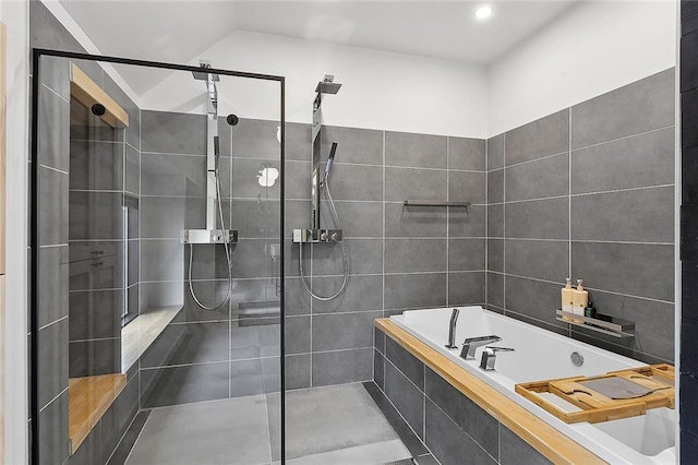 bathroom with shower with separate bathtub and tile flooring