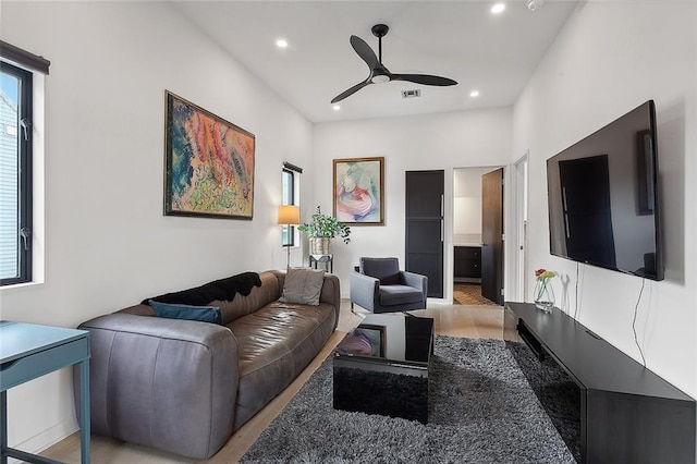 living room featuring ceiling fan and hardwood / wood-style floors