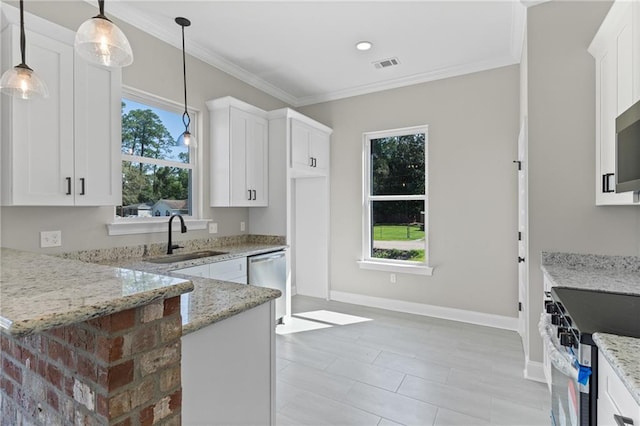 kitchen featuring decorative light fixtures, sink, light stone counters, and white cabinets